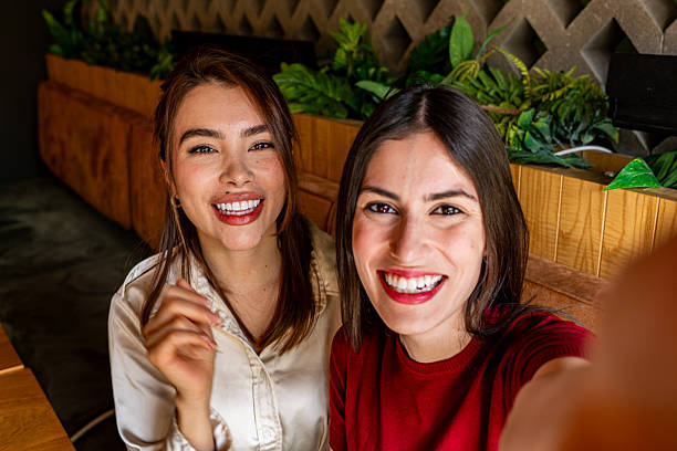 istock Two Young Women Taking a Selfie in a Restaurant 2222106519