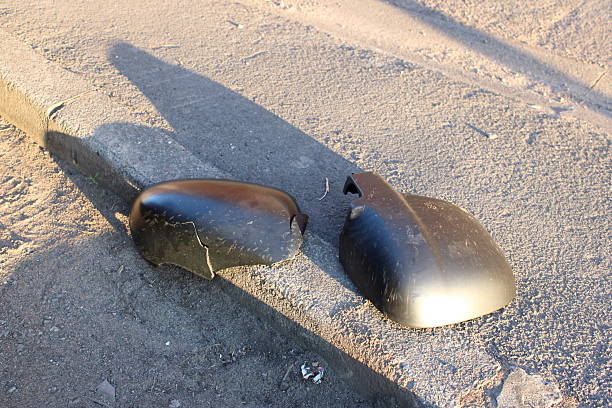 istock Broken Side Mirror on Pavement Detail in Sunlight Closeup 2222107986