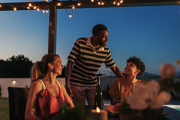 istock Friends enjoying dinner together at vacation home 2222109270