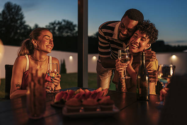 istock Friends enjoying dinner and wine on a summer evening 2222109279