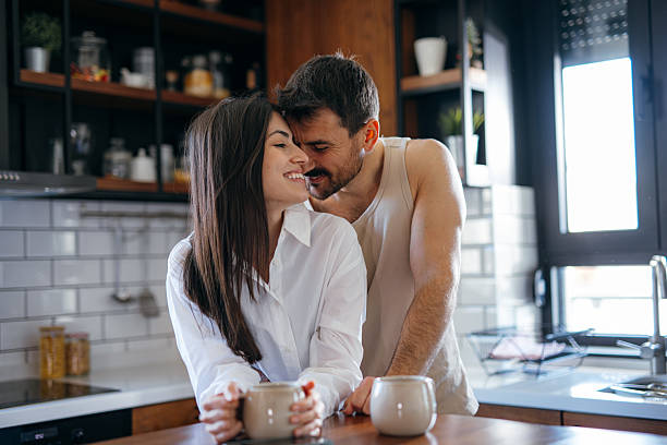 istock Young couple sharing a tender moment in the kitchen while having breakfast 2222109490
