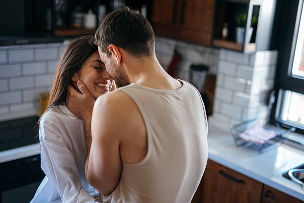 istock Couple Embracing Tenderly in Kitchen, Sharing Intimate Moment 2222109672
