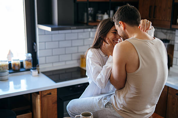 istock Young couple embracing in the kitchen 2222109677