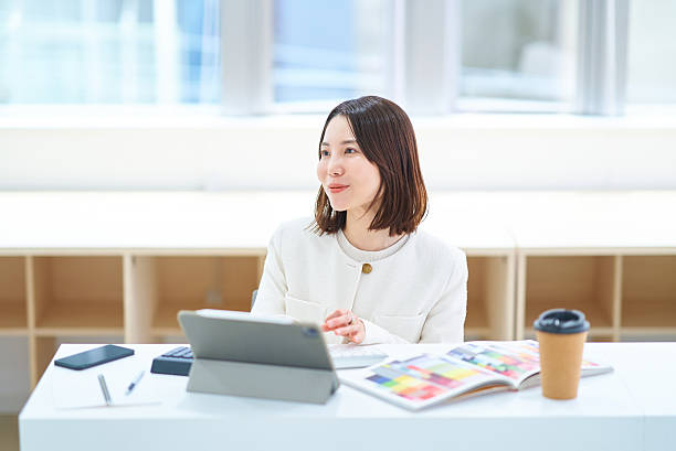 istock A woman in a suit working indoors 2222109924