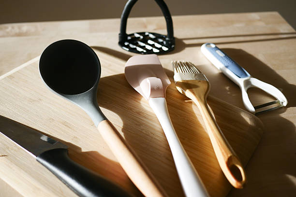 istock Kitchen utensils on a wooden cutting board in natural light 2222110239