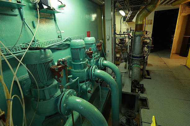 istock Cruise ship engine room interior with water tight doors electrical and diesel engines, water pipes, measuring instruments, diesel engines 2222110395
