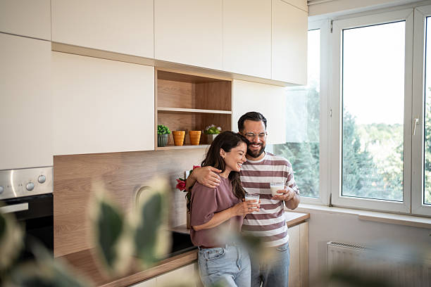 istock Happy couple embracing and drinking milk in modern kitchen 2222110550