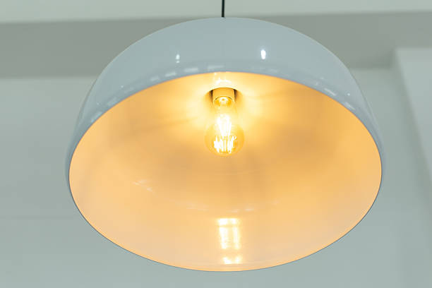 istock Modern pendant lamp, white lampshade, glowing light bulb, minimal interior, warm ambiance 2222110655