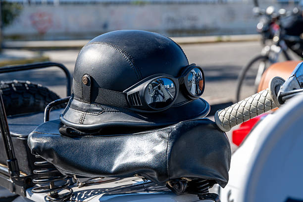 Young woman putting on motorcycle / motorbike helmet