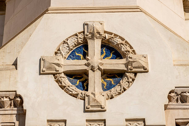 istock Stone cross with blue mosaic in cathedral wall 2222110956