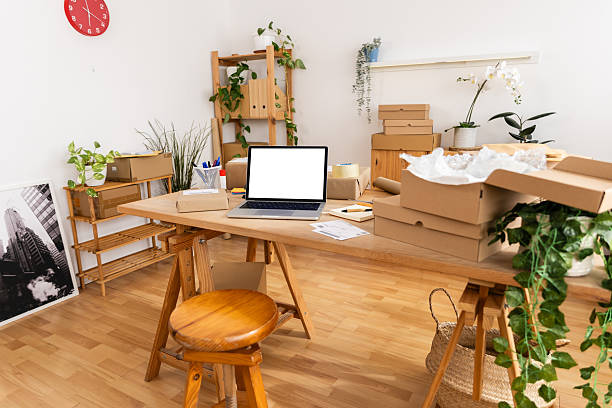 istock Entrepreneur preparing packages for shipping in home office 2222111018
