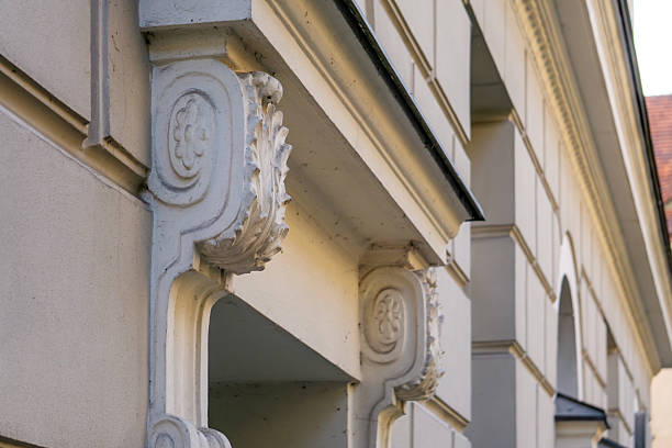 istock Architectural detail showing decorative corbels under the cornice on a bright, renovated neoclassical building facade, illuminated by sunlight. 2222111722