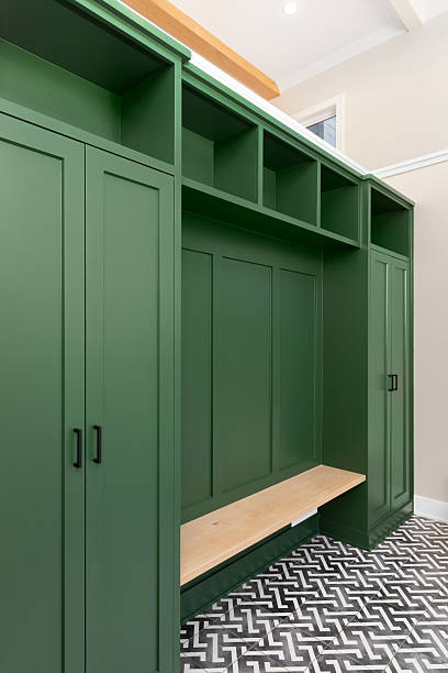 istock A mudroom with green built-in shelving and pattern tiled floor. 2222112612