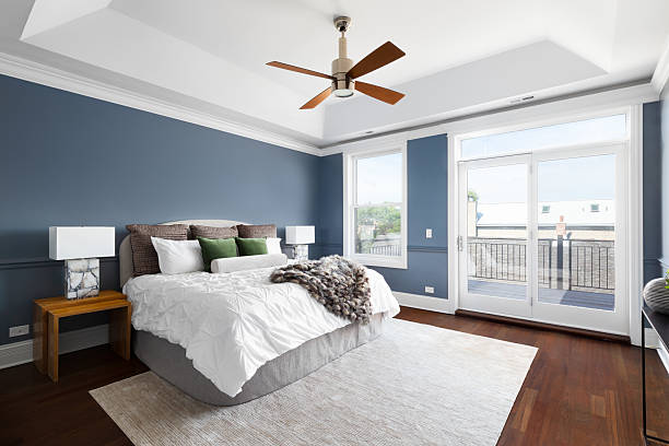 istock A bedroom with blue walls, coffered ceiling, and cozy bedding. 2222112803