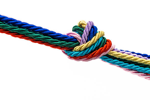 Braided cords tied together in the shape of an infinity sign on a blue background. Communication concept. Place for text