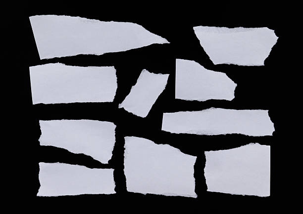 istock Pieces of torn paper on black background 2222113208
