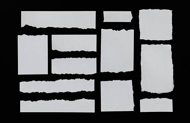 istock Many pieces of torn paper on black background 2222113231