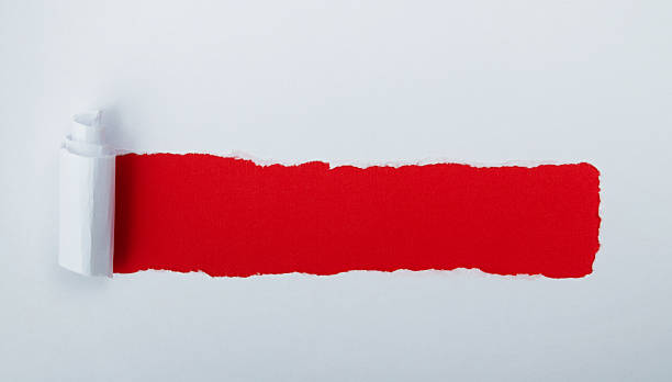 istock Torn white paper revealing red background 2222113280