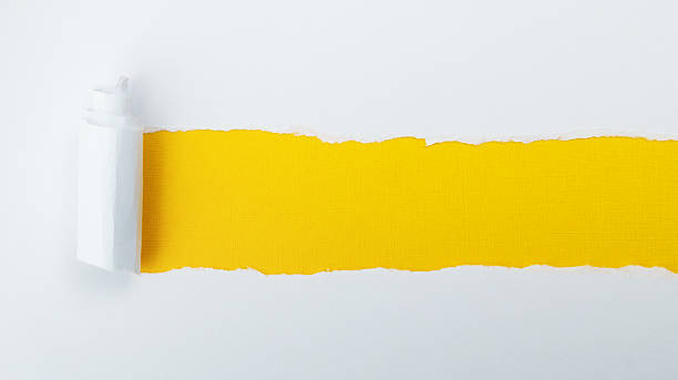 istock Torn white paper revealing yellow background 2222113284