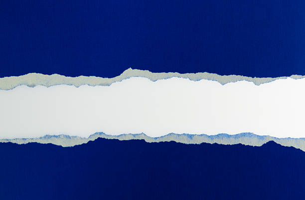 istock Torn blue paper revealing white background 2222113922