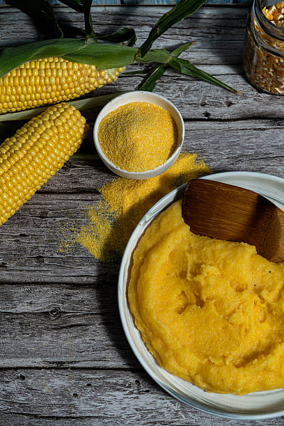 Fresh cornmeal and polenta on rustic wooden table