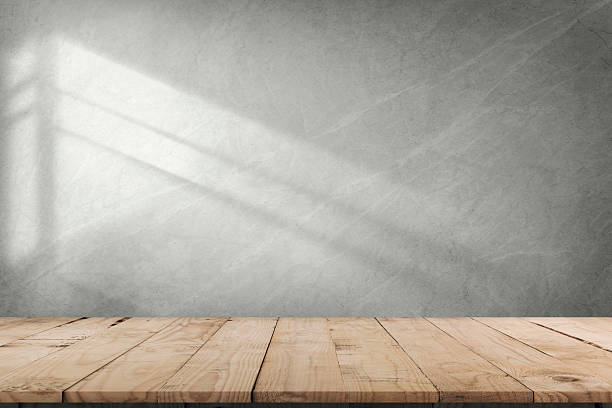 istock Empty of wood table top on abstract White concrete wall with  sunlight shadow reflected. For montage product design display mockup 2222118389