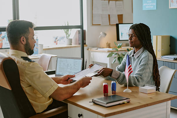 istock Officer Handing Documents to Woman in Office Setting 2222119555