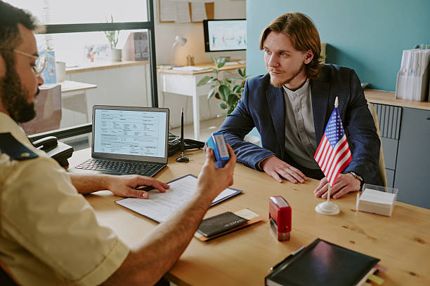 istock Discussing Immigration Process in Office with American Flag 2222119566