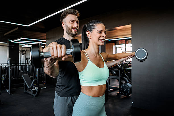 istock Working Out with Dumbbells With Fitness Instructor 2222120341