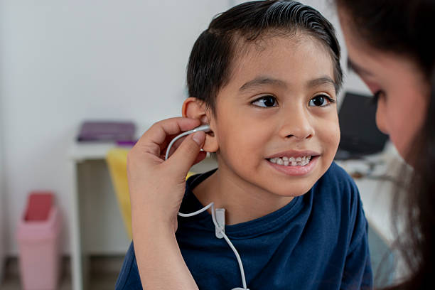 istock Pediatrician performing hearing test on smiling child in doctor's office 2222123409