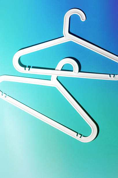 istock Top view White Plastic hangers, minimal style layout on teal blue gradient background, Clothes rack for organizing clothes in closets or retail stores, fashion, organization concept, copyspace 2222124581