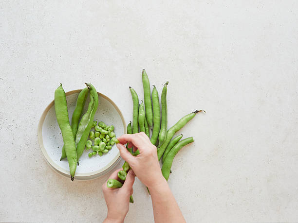 istock Chef preparing fresh broad beans for a healthy vegetarian meal 2222124731