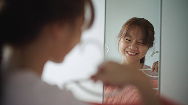 istock Teenager getting dressed in front of a mirror. 2222126355