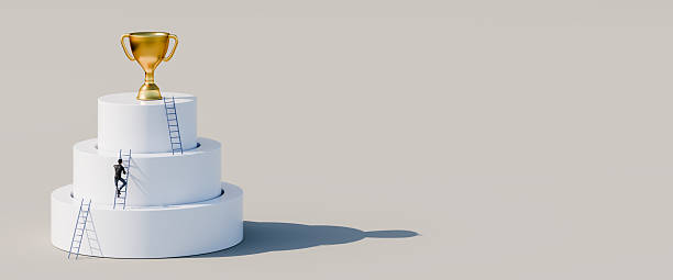 istock Man climbing ladders leaning against concentric cylinders up to golden trophy as the final goal. Career, competition, corporate ladder concept. Web banner format with copy space 2222126535