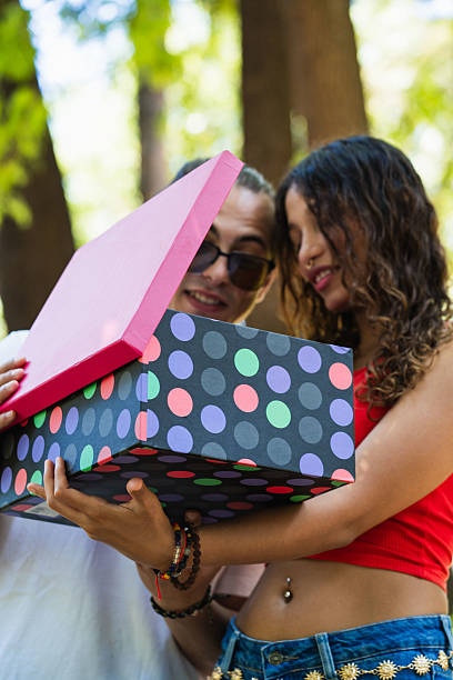 Portrait of a boyfriend giving a gift to his girlfriend