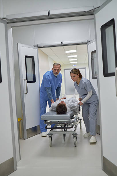 istock Middle Aged Man and Woman Transporting Patient 2222128621