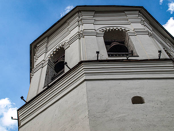 istock Bell tower on the background of a cloudy sky with a bell 2222128805