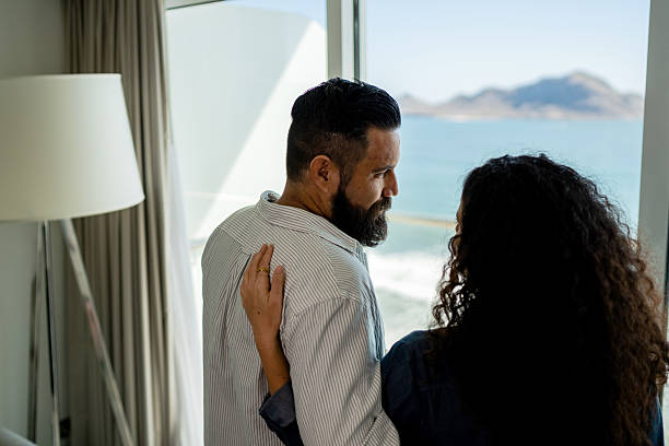 istock Tourist couple talking on hotel room 2222130301