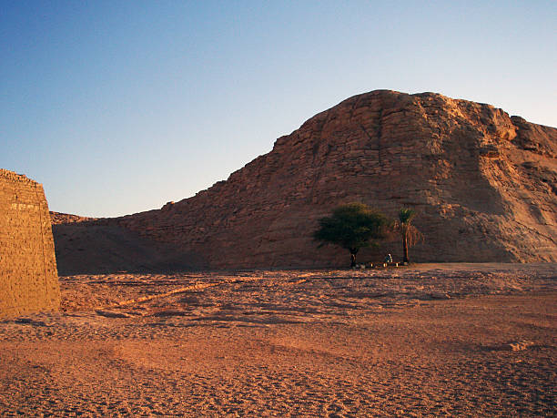 person resting in the distance under a tree at abu simbel mountain