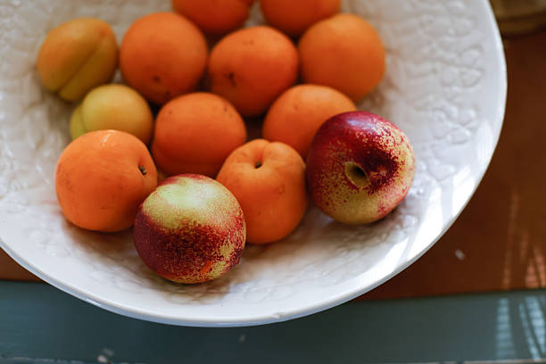 istock Ripe stone fruit in textured ceramic white bowl 2222135692
