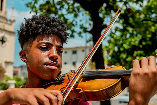 Young man playing violin outdoors
