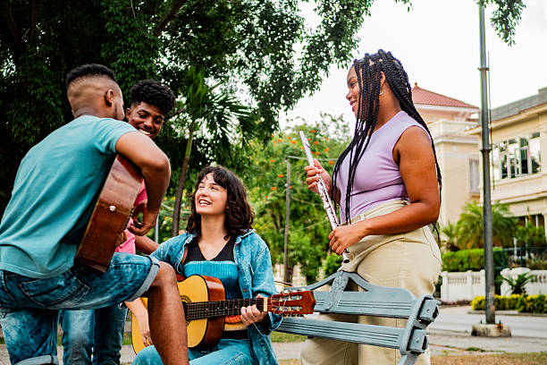 Musician friends talking on public park