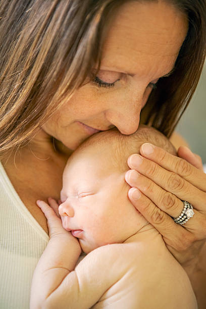 istock Tender Moment Mother Holding Newborn Close 2222138768