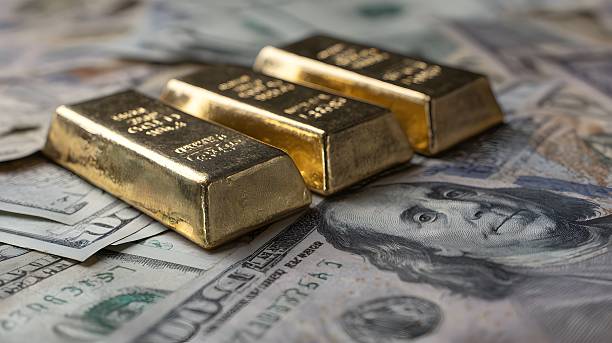 istock Gold bars on US dollar bills, symbolizing wealth. 2222140016