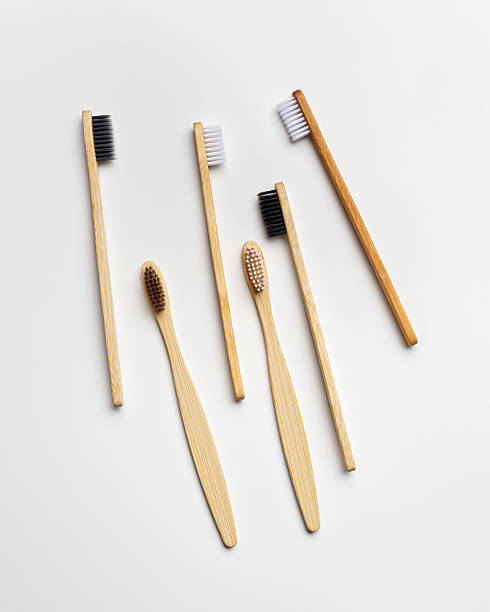 istock Top view of eco-friendly bamboo toothbrushes arranged on grey white background, emphasizing sustainability and minimalism, Natural organic bathroom beauty product concept, dental hygiene, flat lay 2222140863