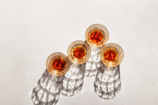 istock Transparent alcohol Glasses with dark shadows at sunlight on beige table, top view minimal style, aesthetic flat lay shiny glass sparkling at natural light, summer strong drink, luxury lifestyle 2222141388