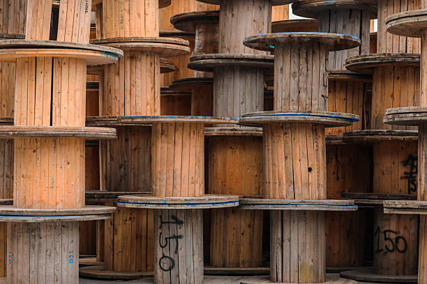 Stacked Wooden Cable Reels in Industrial Yard