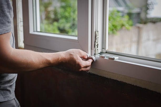 istock One young worker wipes the window frames with a napkin. 2222144277
