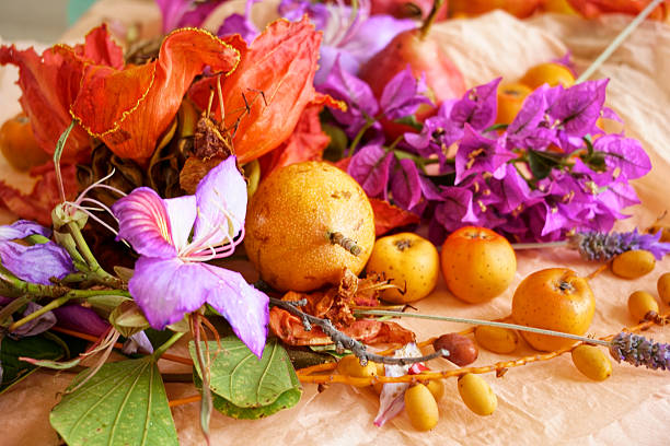 Beautiful still life with fruit, seeds, flowers and leaves on the light table
