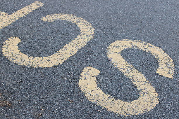istock Yellow painted letters CS on an asphalt road 2222145579